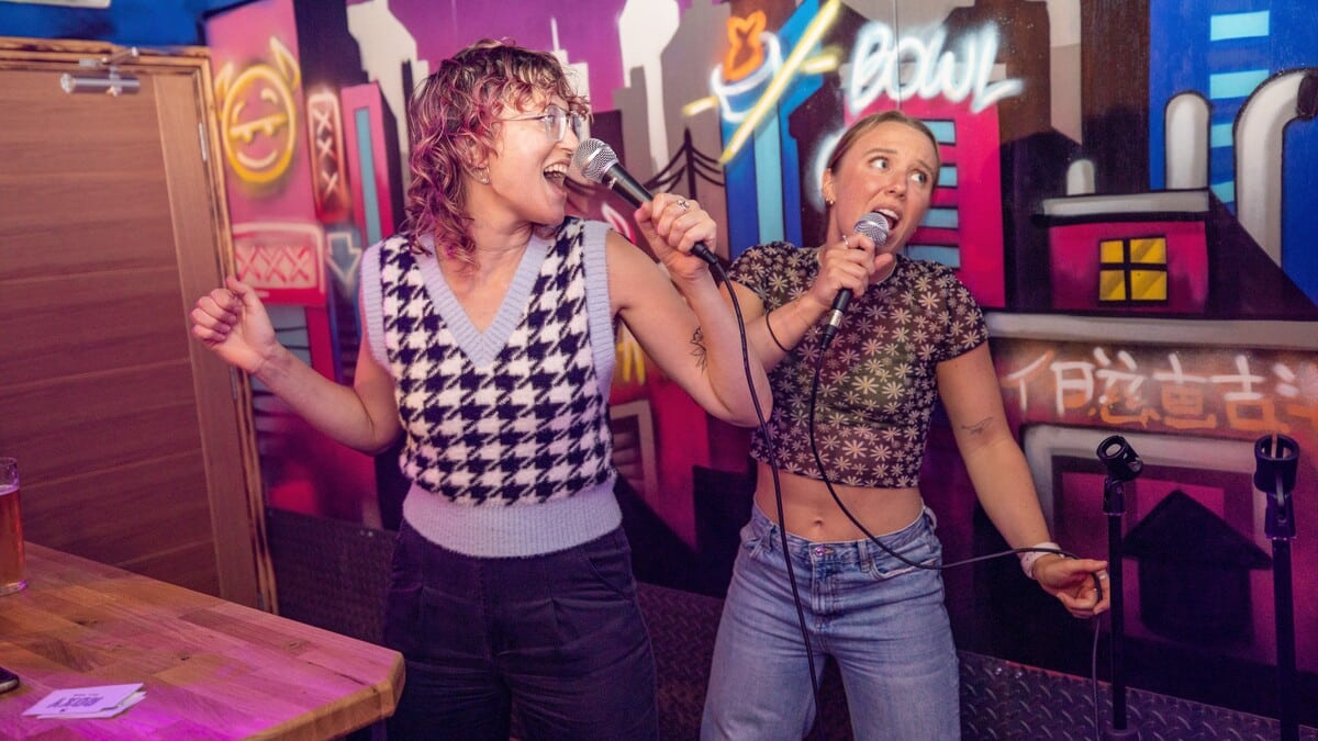 Two people singing karaoke at Roxy Ball Room