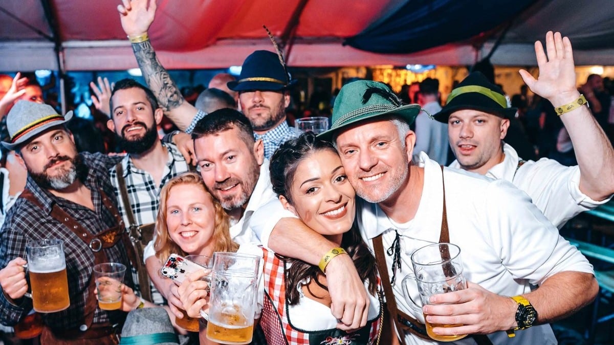 A group of friends drinking beer and dressed up for Oktoberfest in Birmingham at Luna Springs