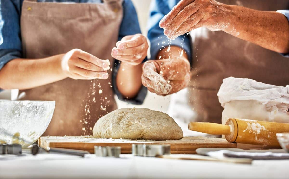 Close-up of two people's hands baking 