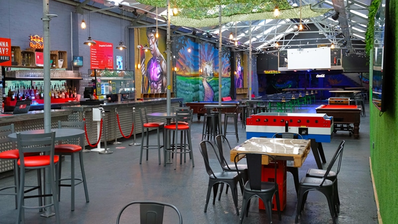 One of the best activity bars in Birmingham, Dropshot, a room full of ping pong tables and walls with colourful street art