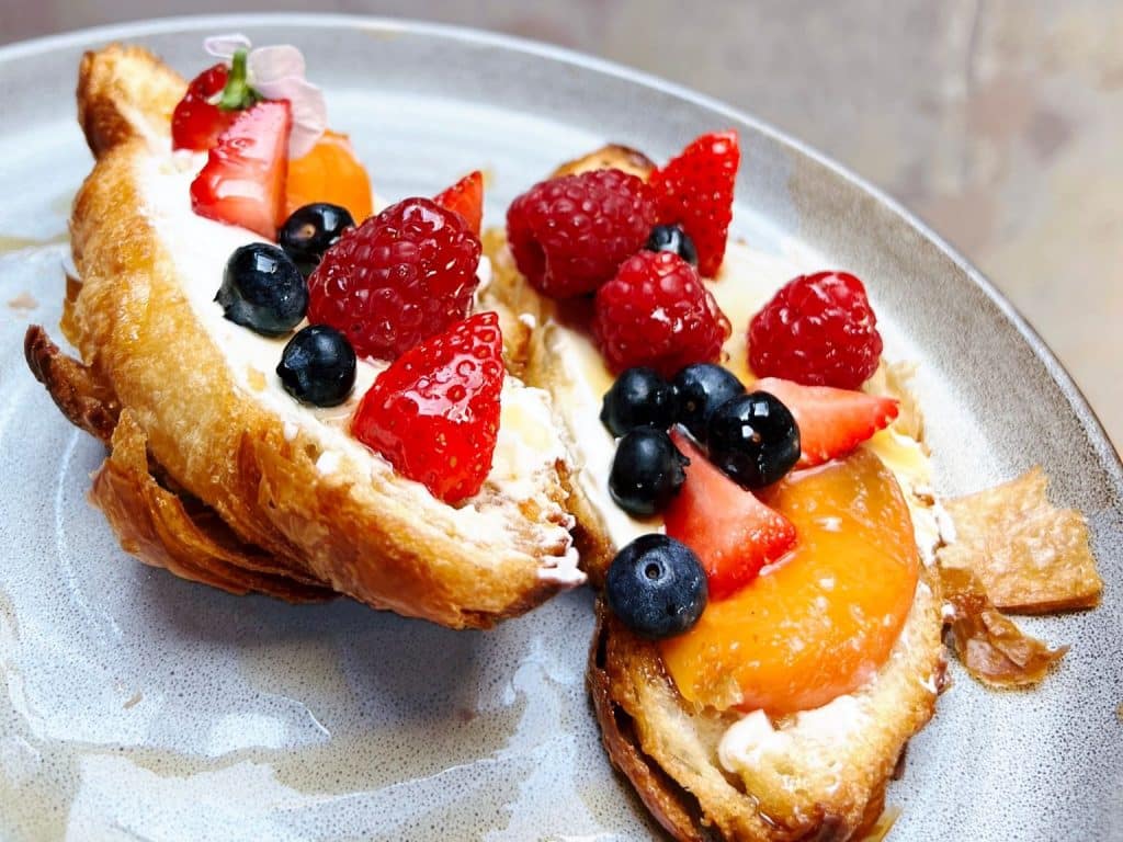 Cream and mixed fruit on a croissant