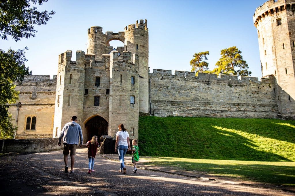 A family walking around Warwick Castle