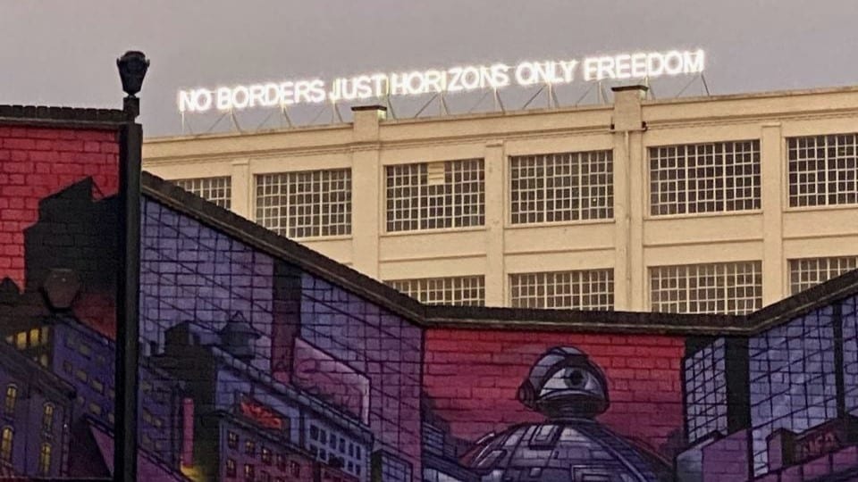 No Borders Just Horizons Only Freedom written on a neon sign