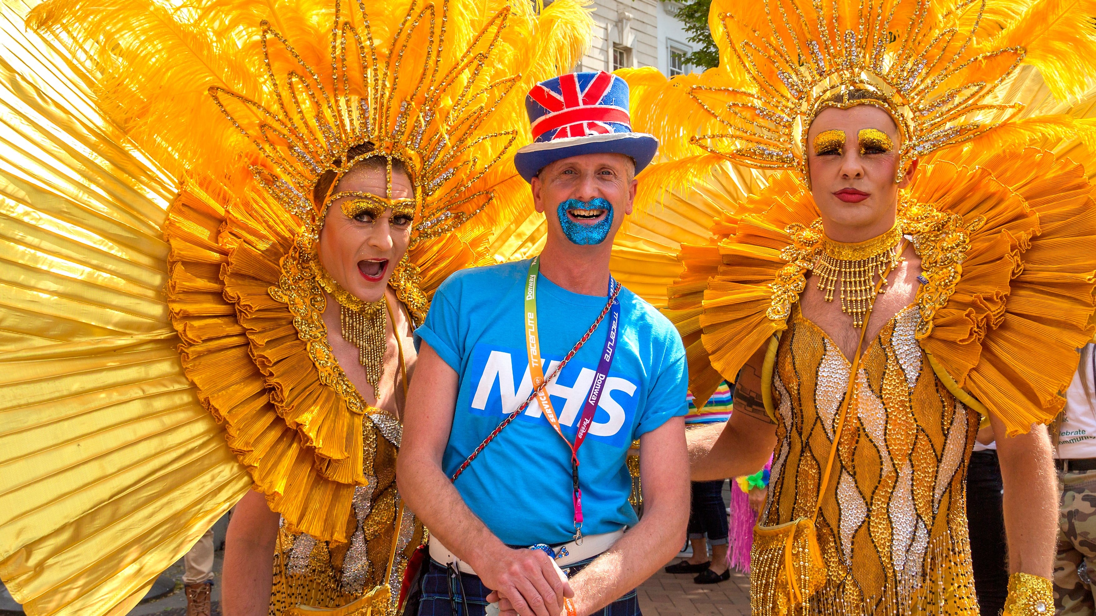Revellers wearing vibrant bright yellow costumes meet up before the Birmingham Pride parade through Birmingham City centre.