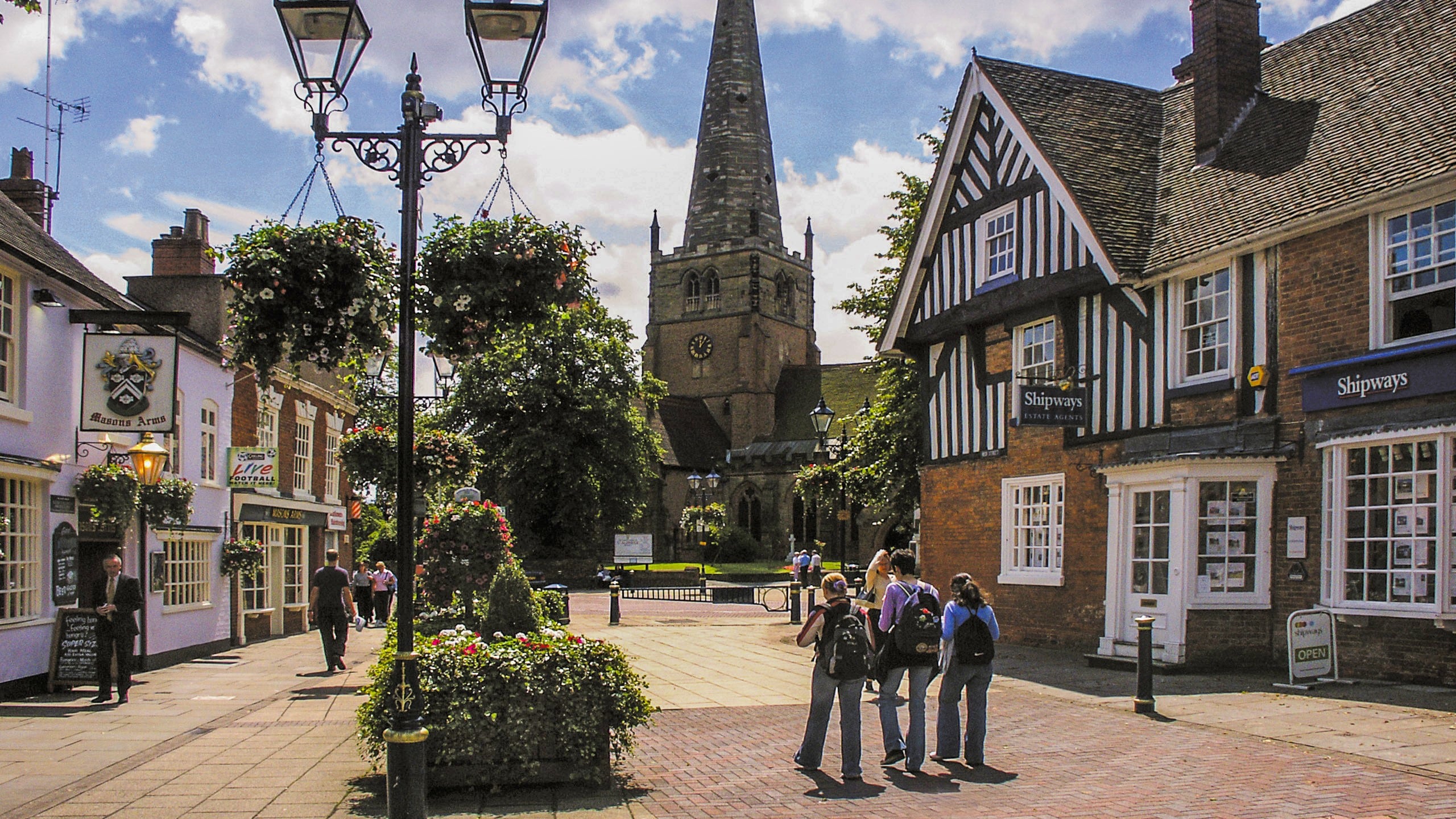 Town centre of Solihull with three people on one of the Birmingham walking tours