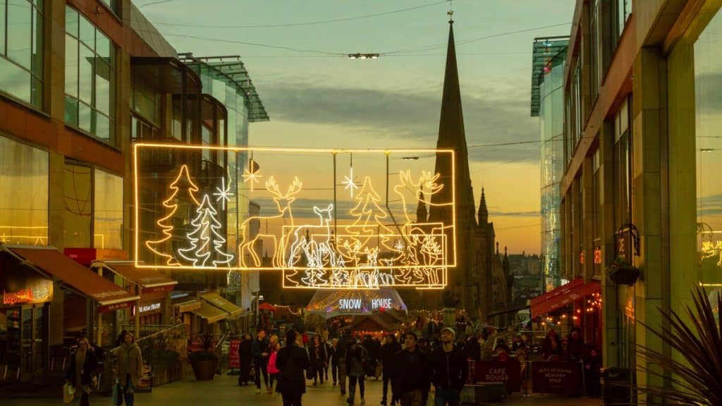 Birmingham, UK - December 2, 2019: People walk past the Christmas lights at the Birmingham Christmas Market