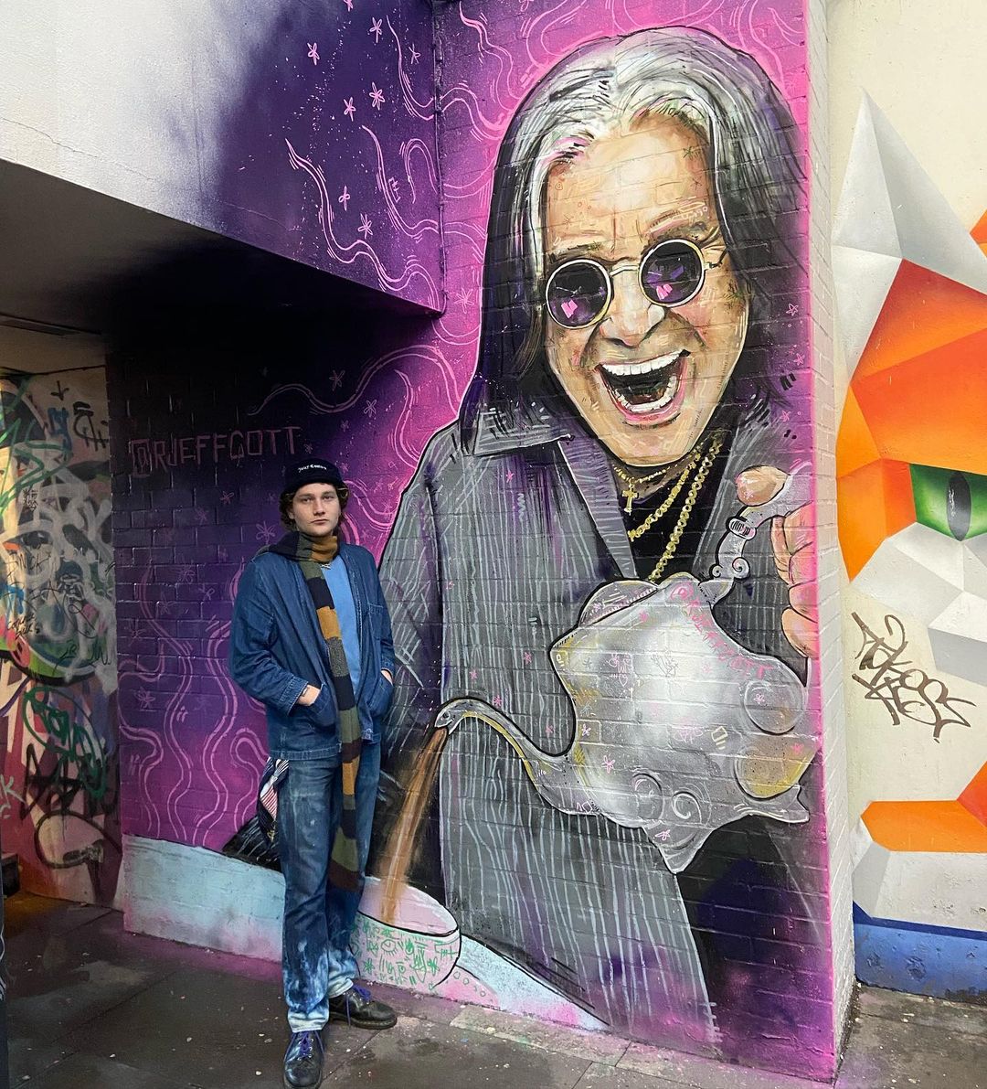 Birmingham graffiti Robbie Jeffcott artist stood next to his Ozzy Osbourne mural 