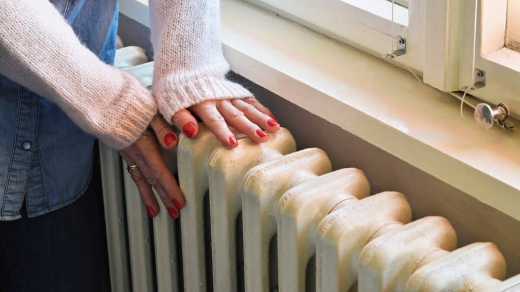 Someone clutching a radiator for warm banks in Birmingham