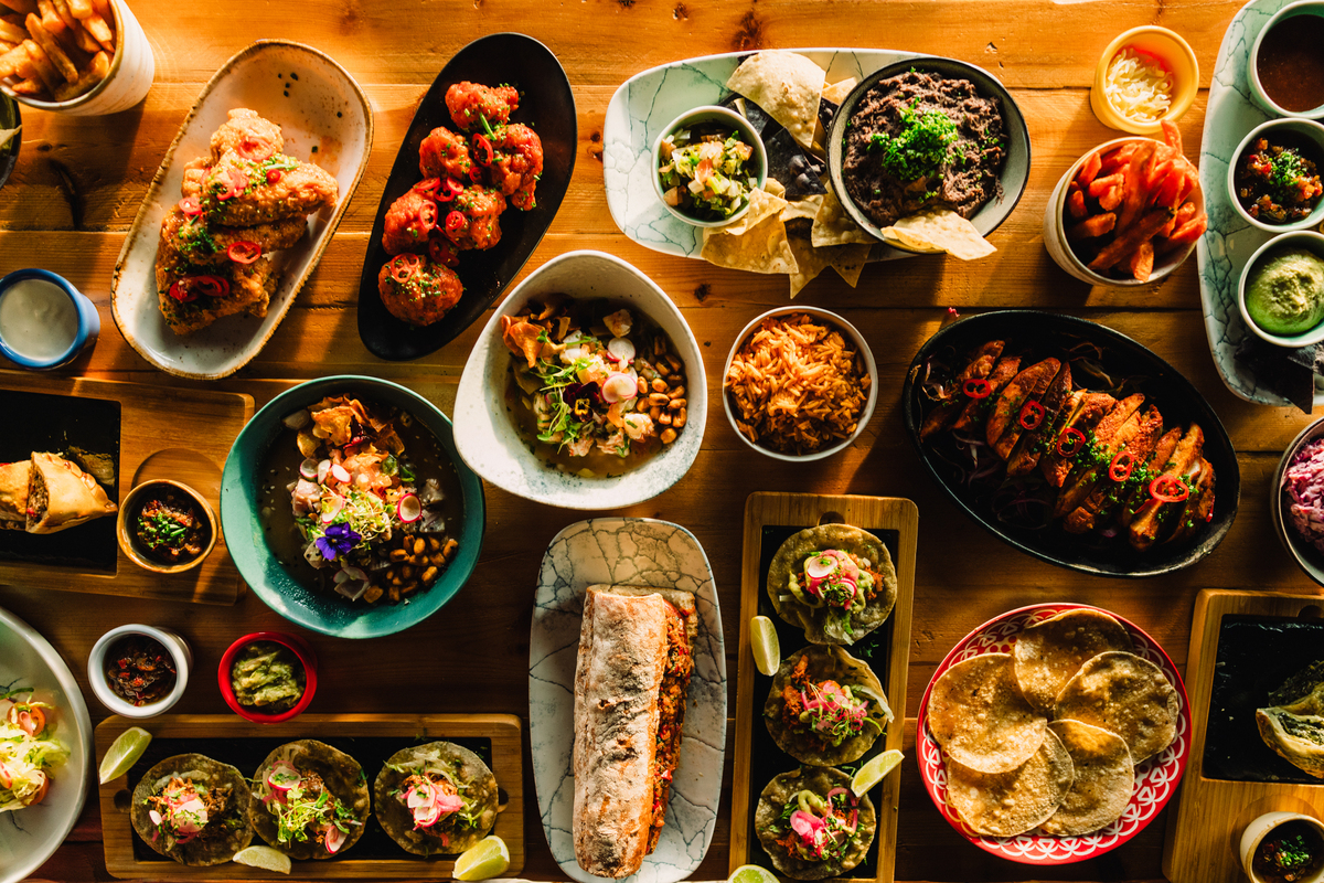 A full table of Latin American street food from Tio Latino, such as tacos, burritos, empanadas and ceviche