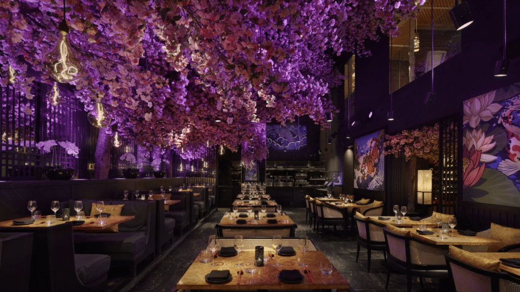 black interoir of the tiktok-worthy restaurant Tattu in Birmingham with cherry blossom trees inside