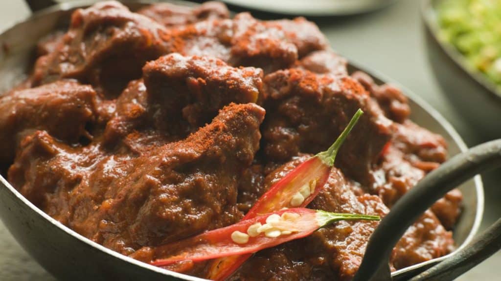 A Meat Phall, considered one of the hottest curry in the world, in Karahi with Naan and Green Chilli Curry