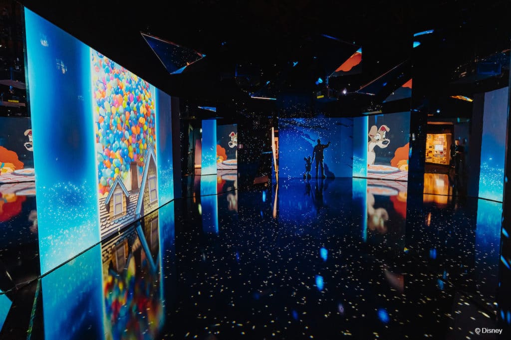 large screens inside Disney100: The Exhibition