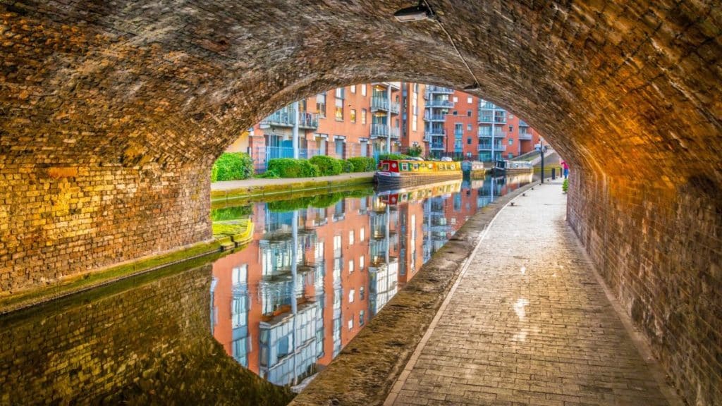 Sunset view of brick buildings alongside a water channel in the central Birmingham canals, England